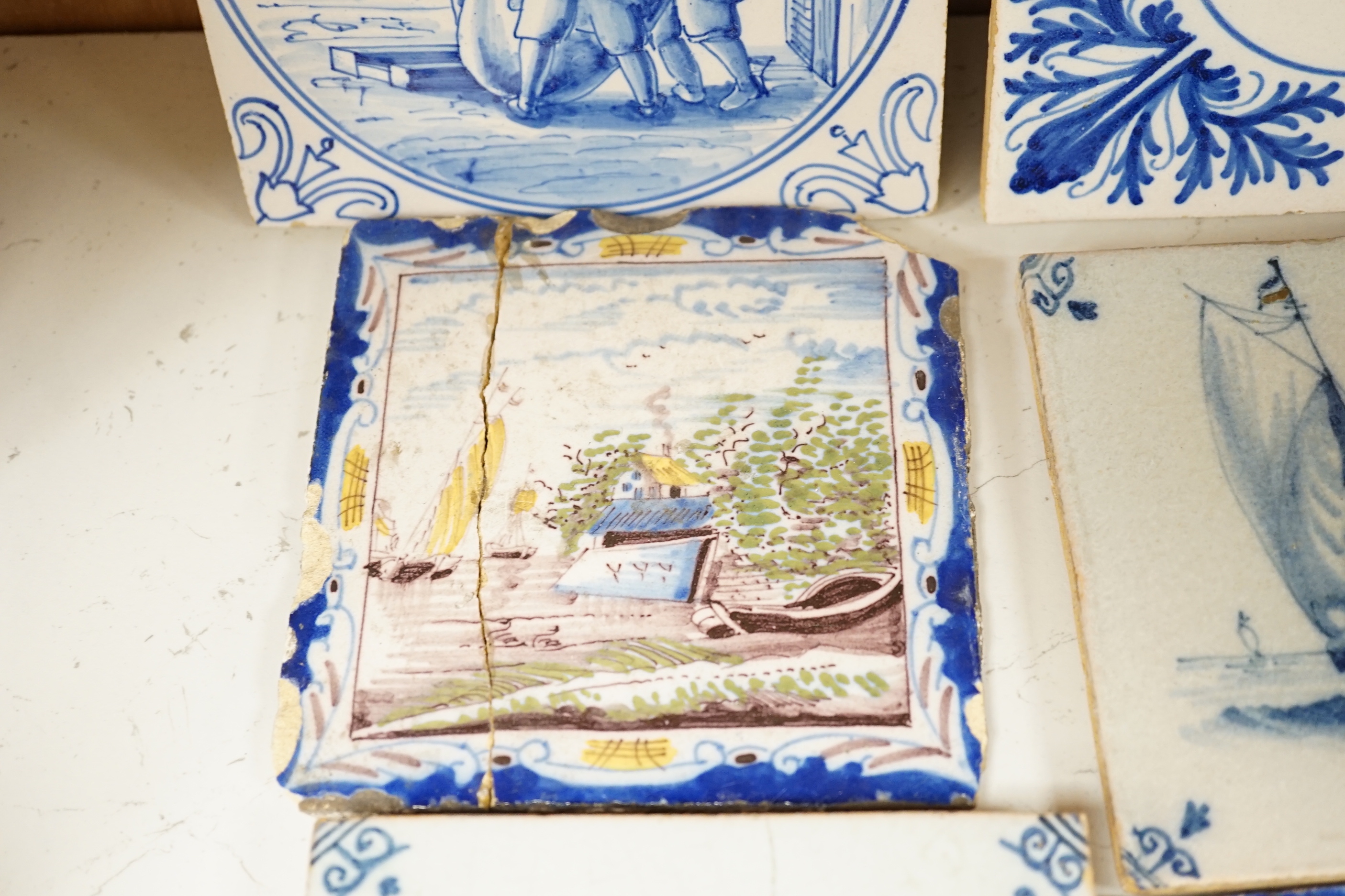 A group of Delft tiles including two polychrome examples and three decorated with ships, 18th/19th century, approximately 12.5cm x 12.5cm (a.f.)